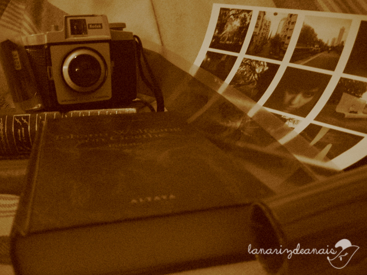 a book, camera and book page on a desk
