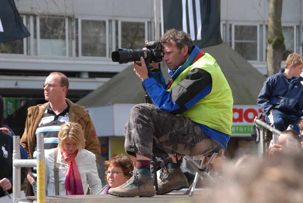 a pographer using a large camera at a meeting