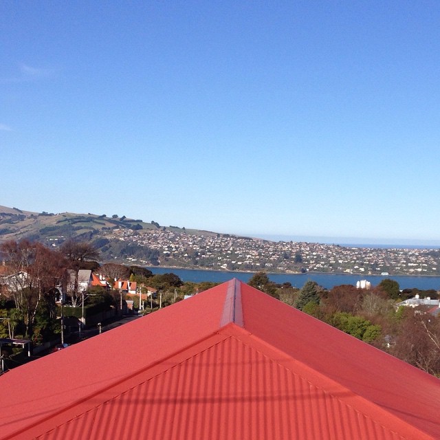 a view of the water and mountains from top of a roof