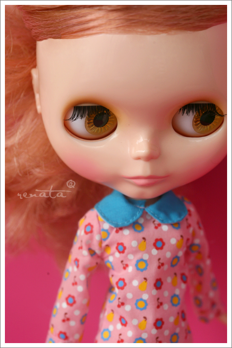 close up of a doll with orange eyes and pink polka dots
