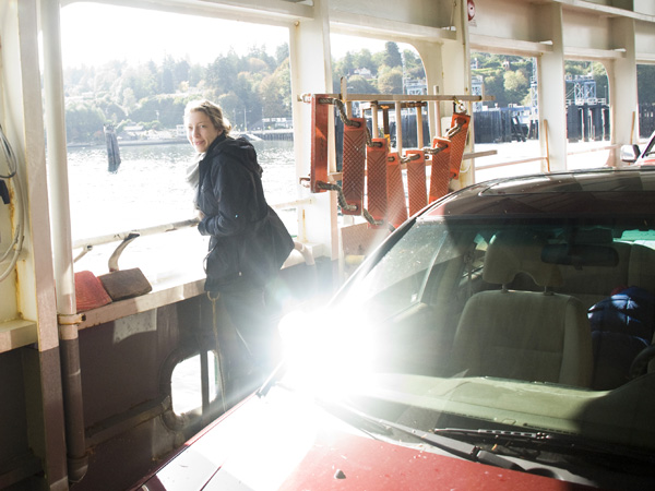 a woman is looking out of a boat window