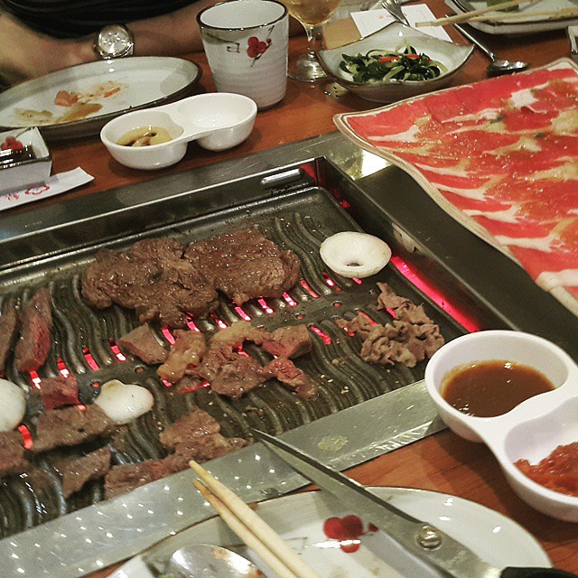 a close - up of steak and other foods on the grill