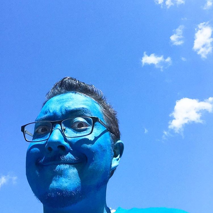 a man with blue face paint on his face