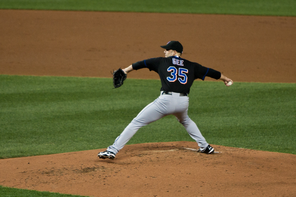 a pitcher pitching a baseball on the mound