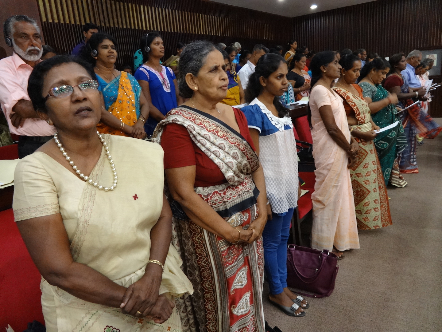 people in long skirts with glasses, watching soing