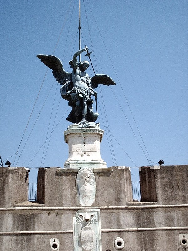 a statue of an angel holding a pole on top of a building