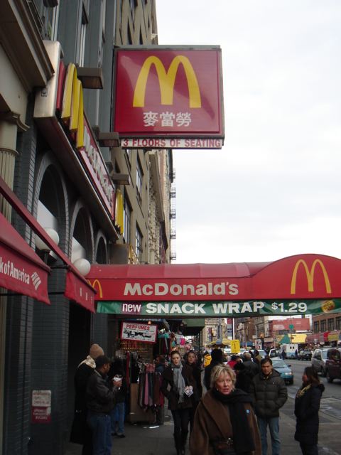 a large mcdonalds sign that is in front of a restaurant
