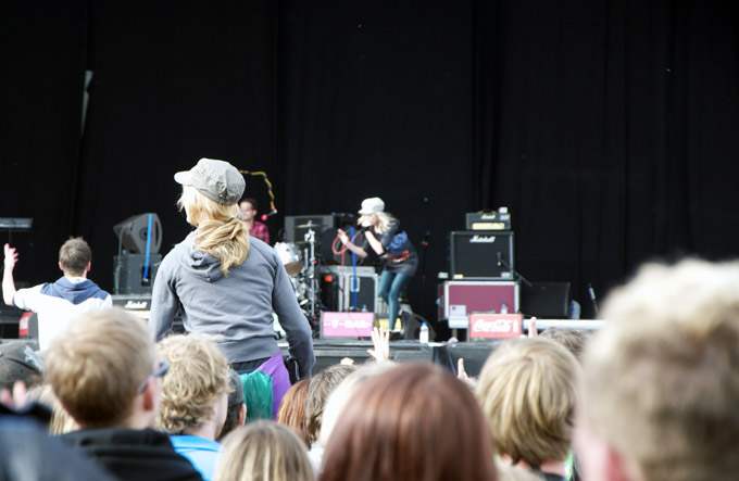 a man and woman standing on stage while people watch