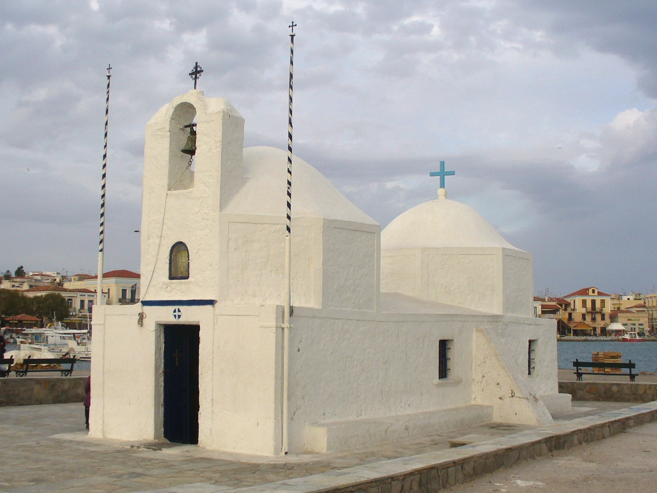 a church is shown with some water and buildings in the background