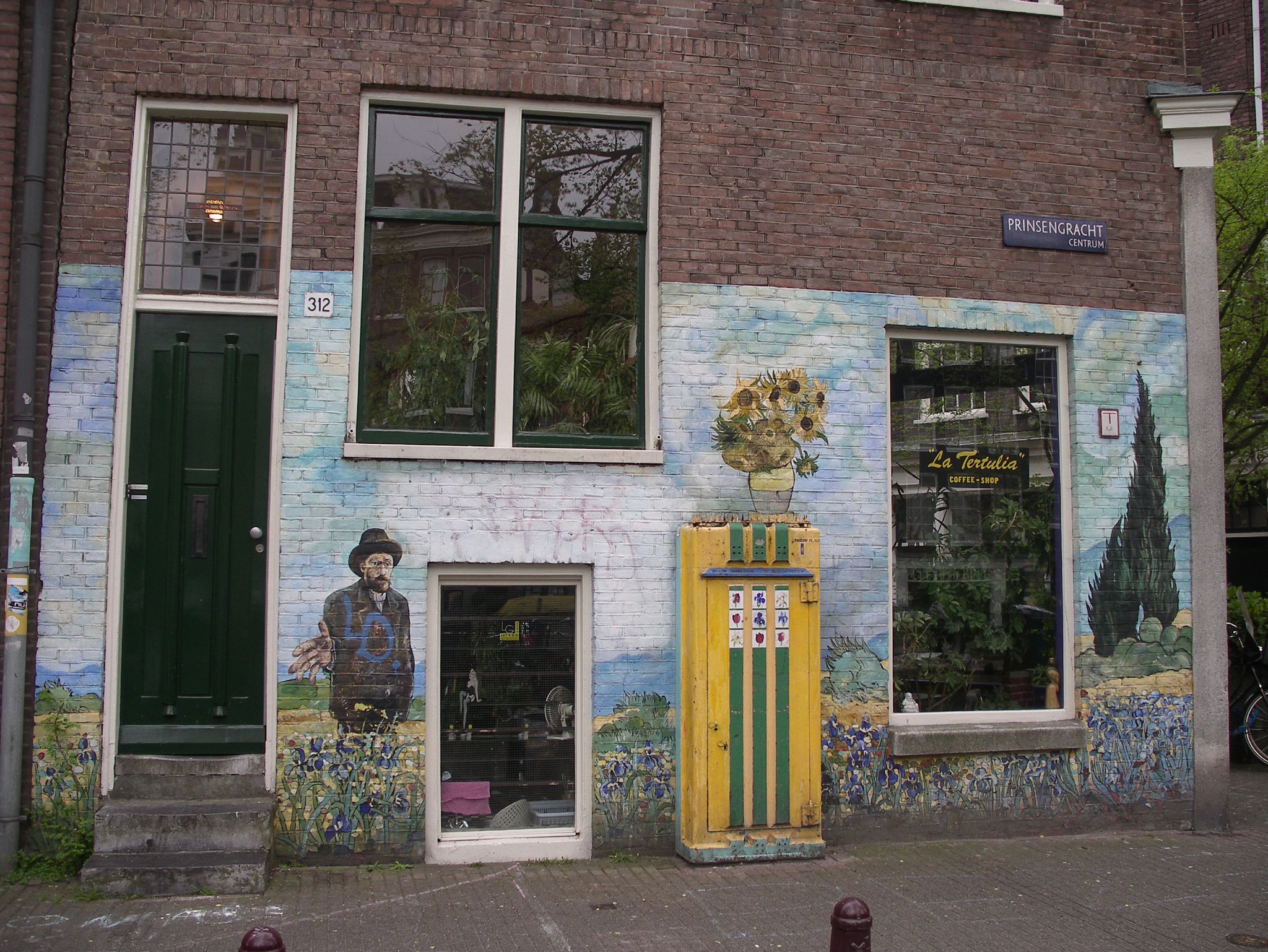 a multi - colored building with two doors and a large painted wall