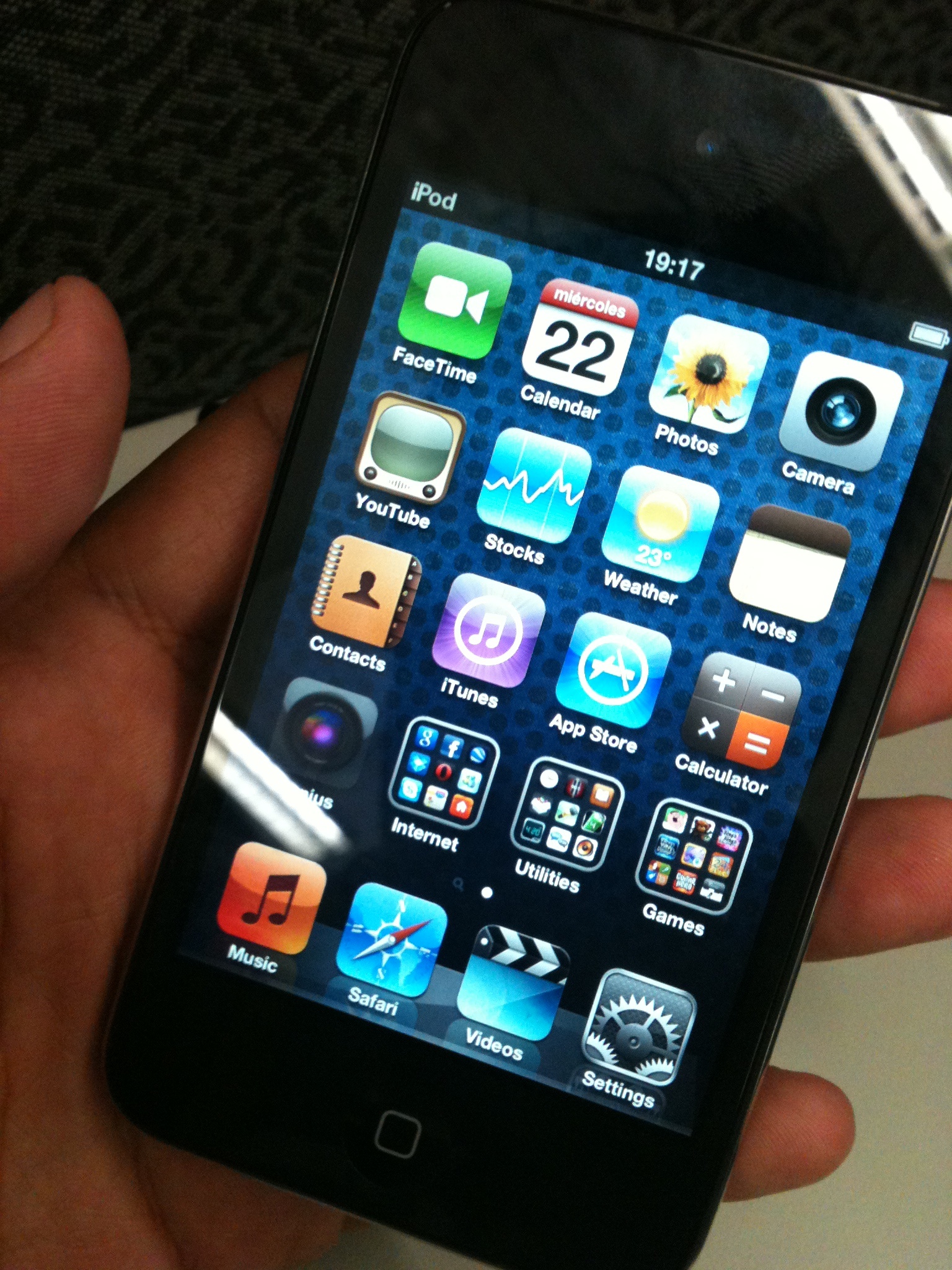 a person holding an iphone with icons and pen