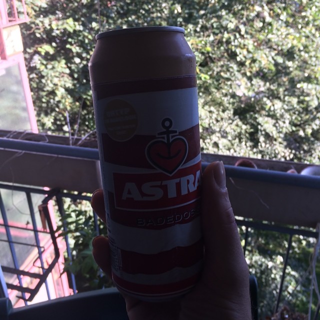 there is a beer on the balcony in the hand