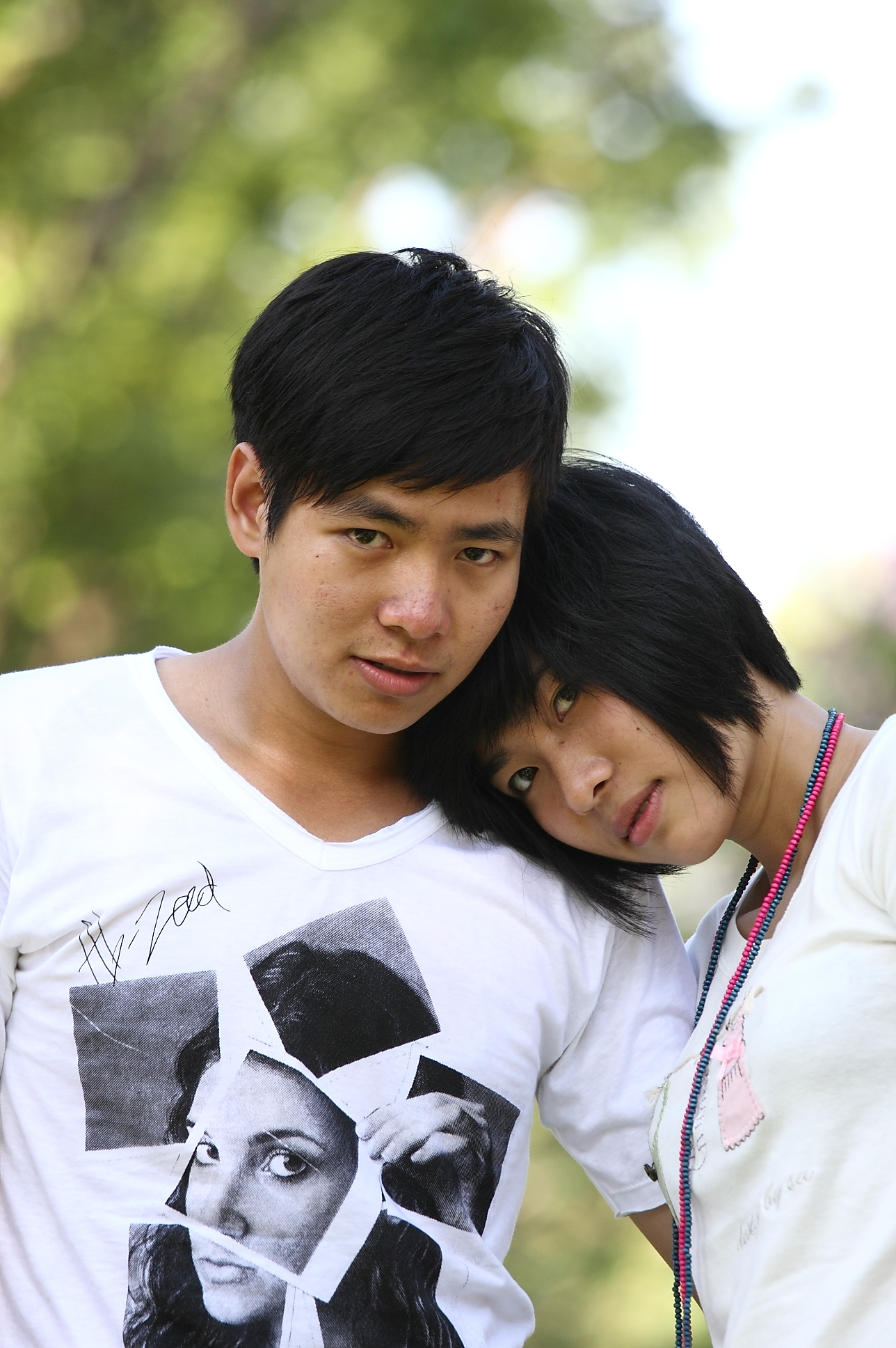 a boy and girl are hugging close together