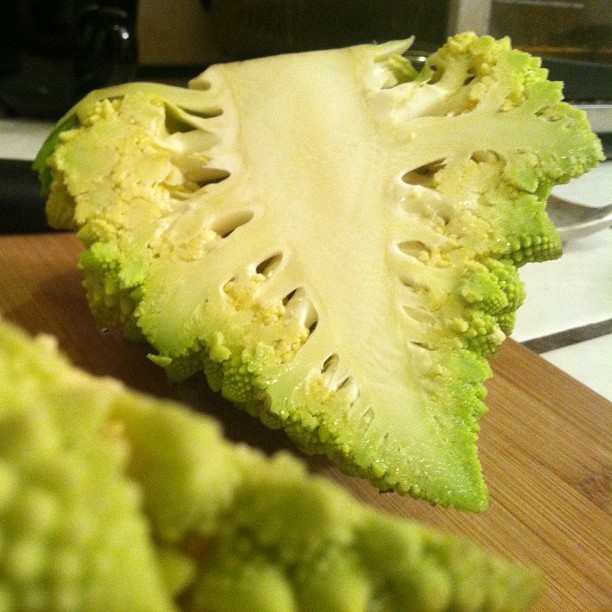 an artichoke being cut up with other pieces