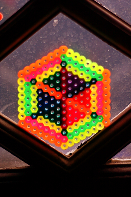 an object with colorful balls sitting behind glass