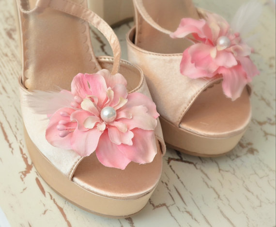pair of pink shoes with flowers on the side