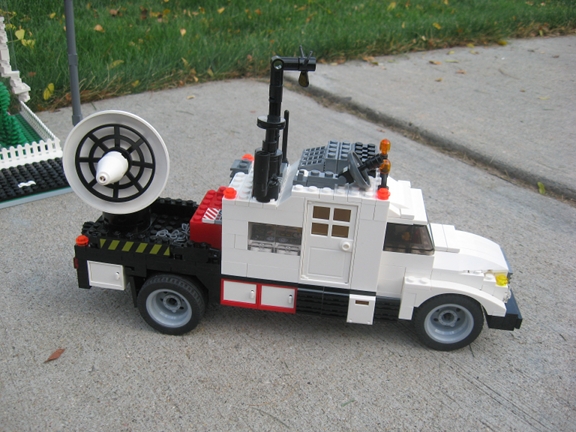 a lego car with a power wheel in the back