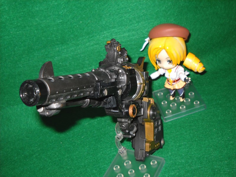 a model is shown next to a toy gun