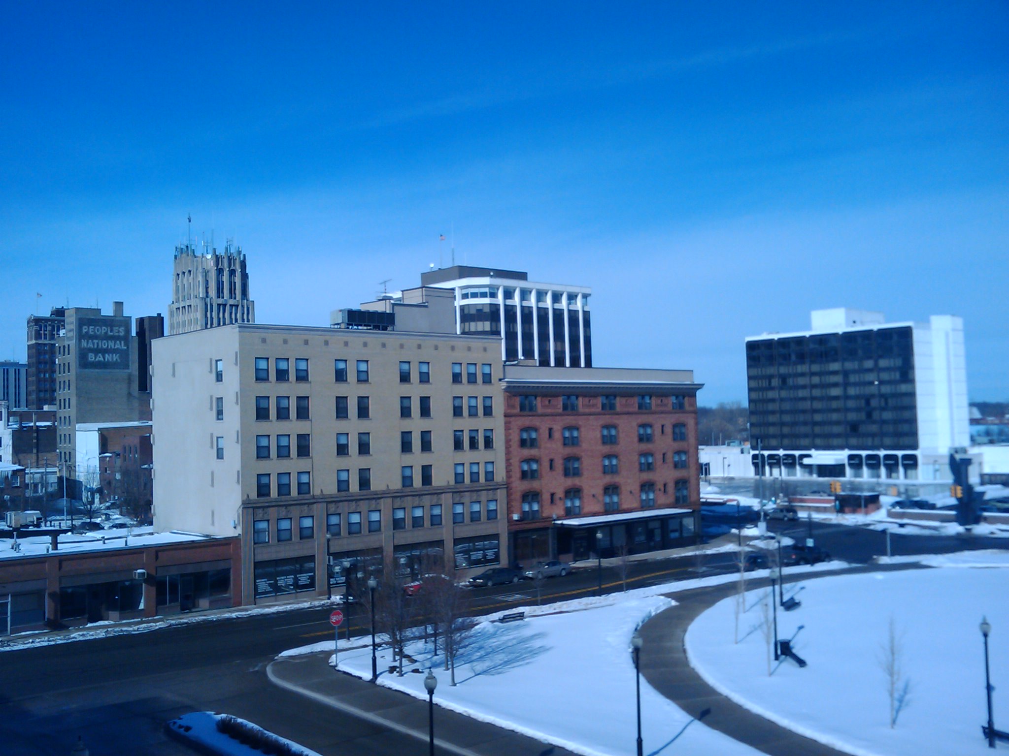 buildings in winter with blue sky and some cars