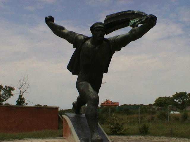 a statue of a man with a baseball glove and book