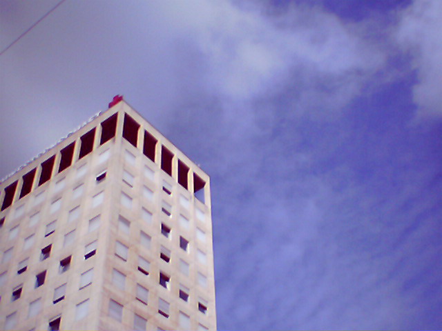 white building surrounded by a blue cloudy sky