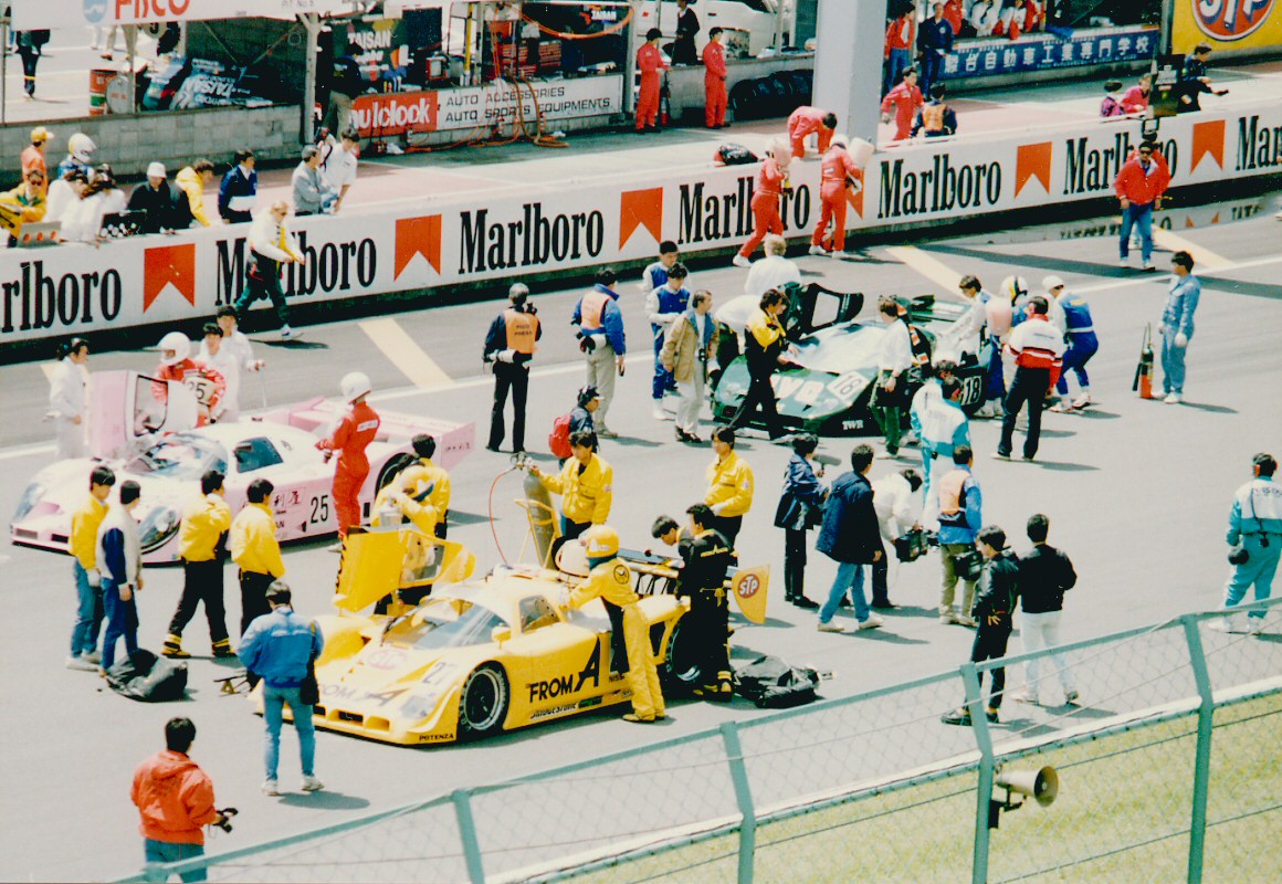 a group of men working on a race car