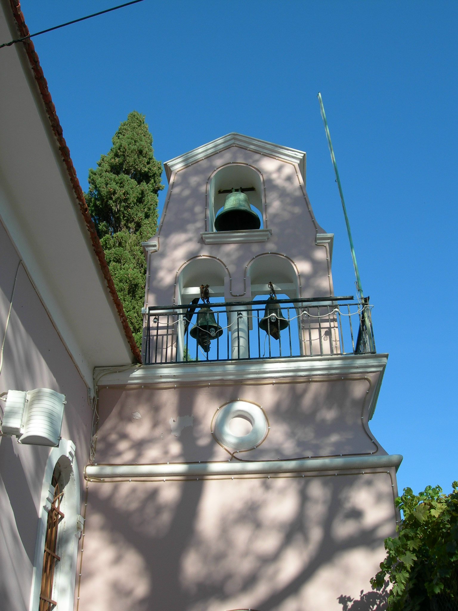 a bell tower stands on top of an older building