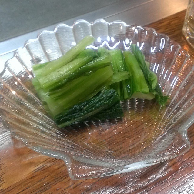 several pieces of green vegetables sit in a bowl