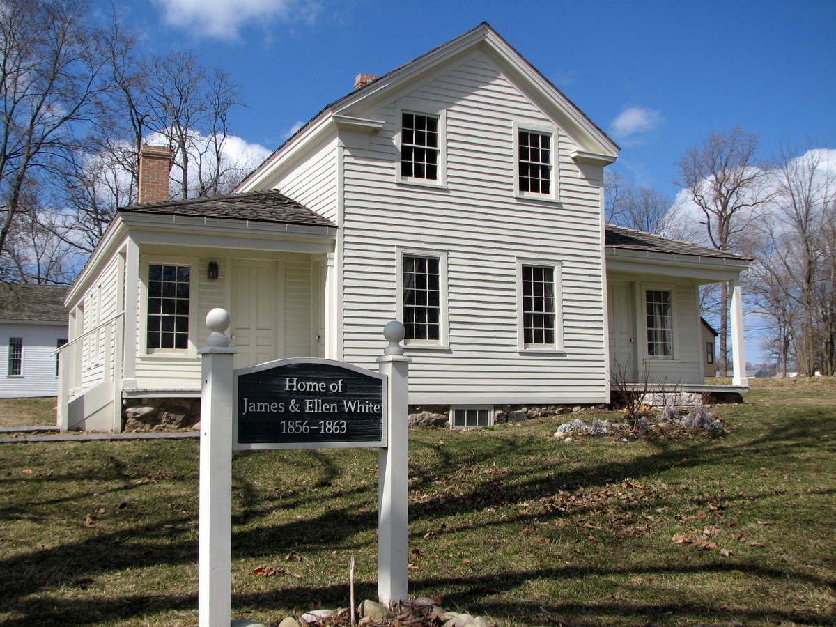 a historic historical house with a sign in front