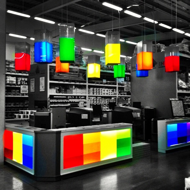 multi colored lighting hanging from a ceiling in a store