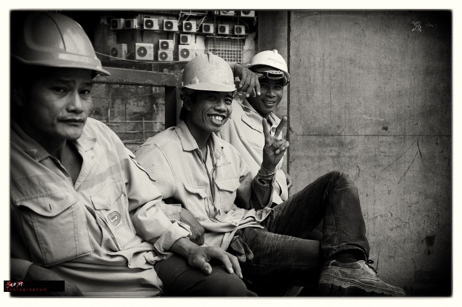 three construction workers wearing helmets and working hardhats