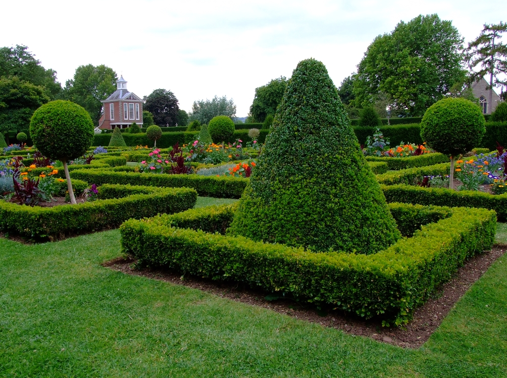 a topiary hedge in the center of a garden