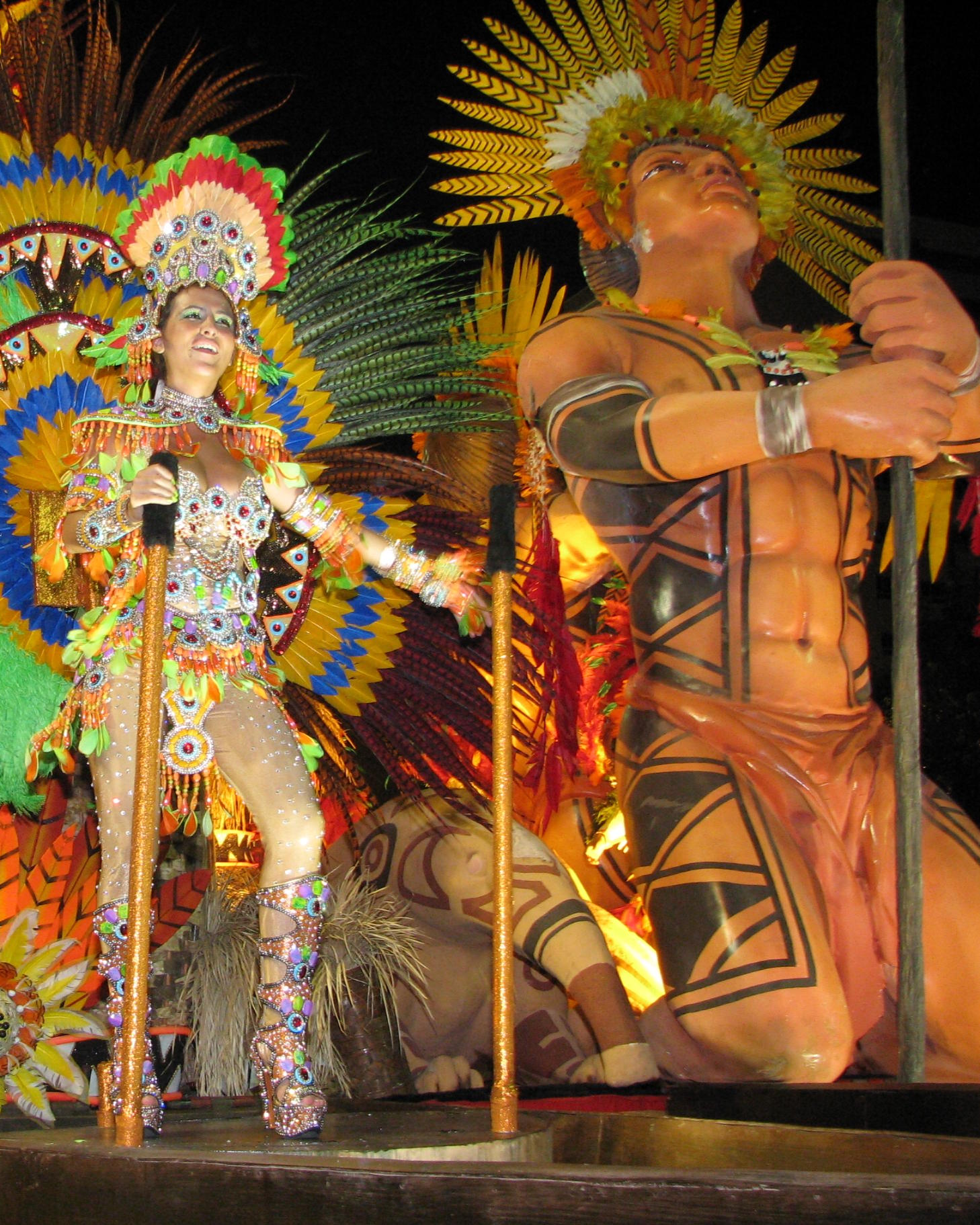 man and woman dancing on a stage with firework costumes