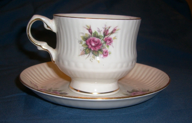 a fancy porcelain cup sitting on a saucer