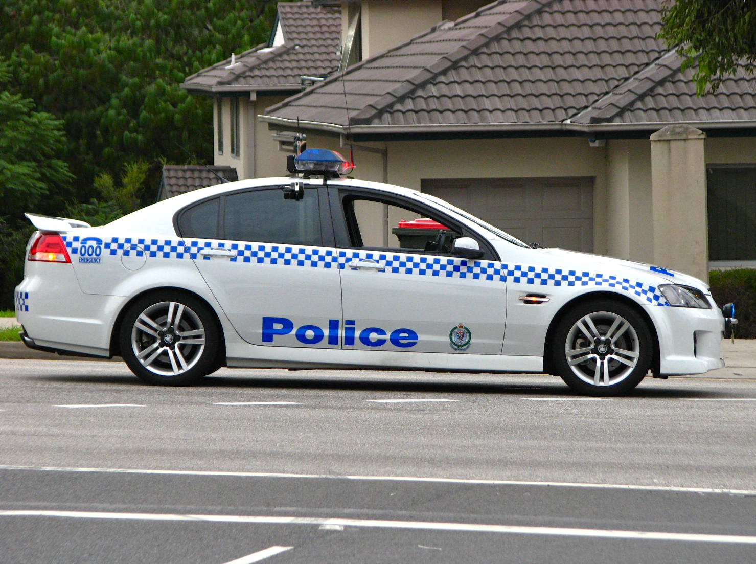 a police car sitting in front of a house