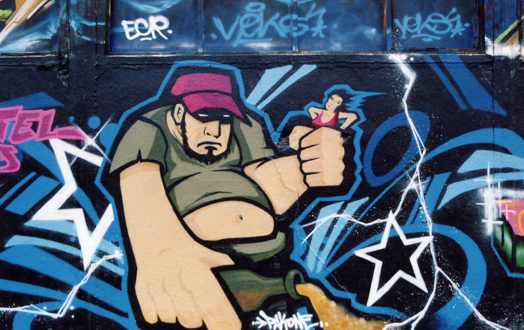 graffiti on the side of a building depicts a man in the middle of a fist bump