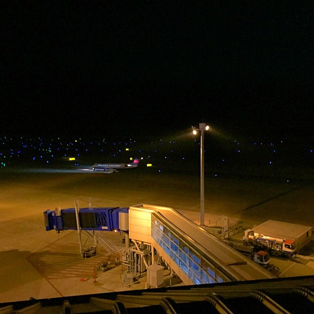a large terminal is on the tarmac at night time