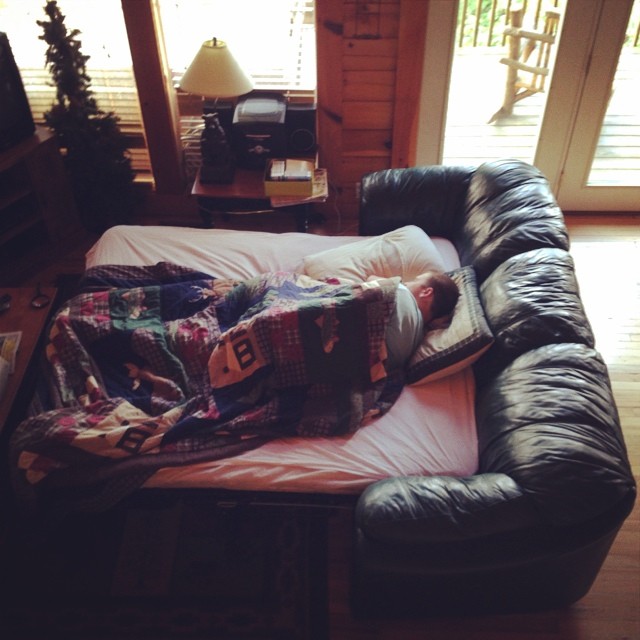 a very large couch with blankets on it