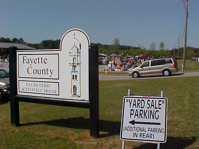 many signs have been placed in a field for cars to drive by