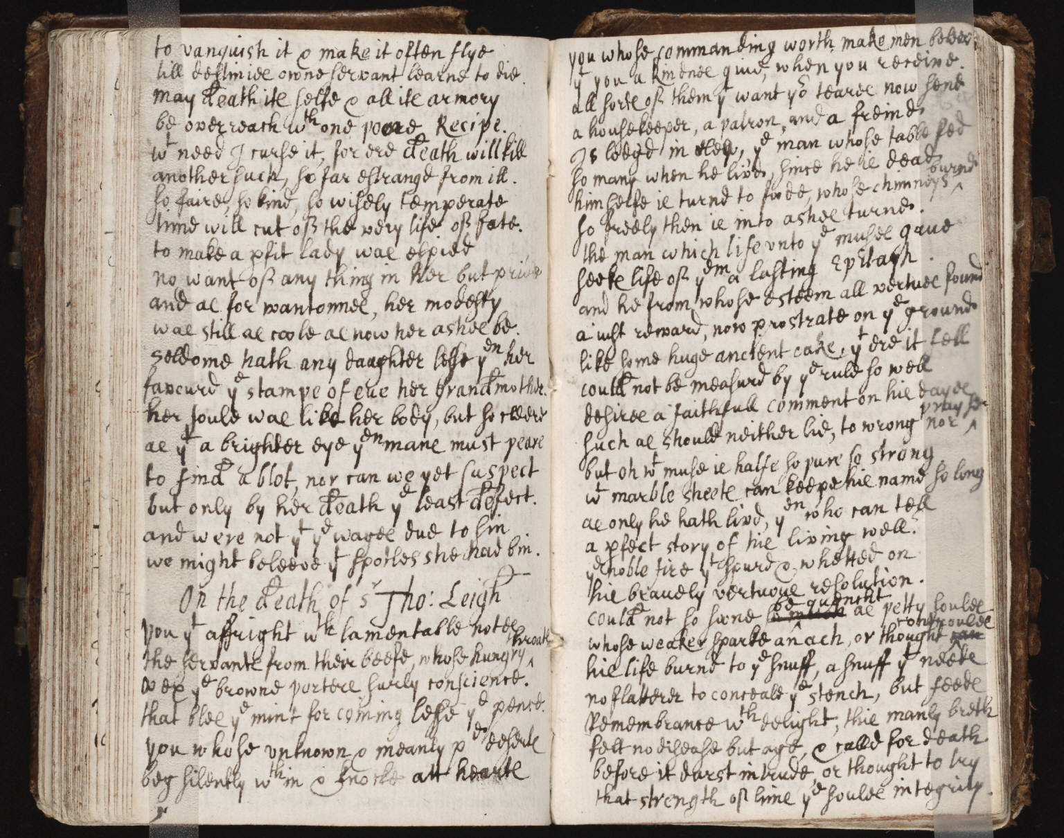 an old handwritten text book is open on a black surface