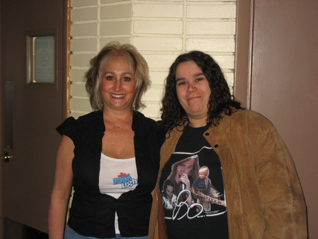 a woman in a black shirt standing next to another woman
