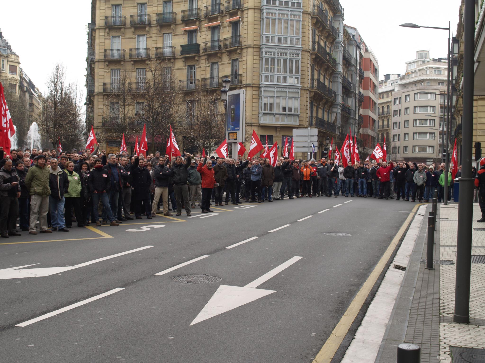 a group of people hold flags in a row