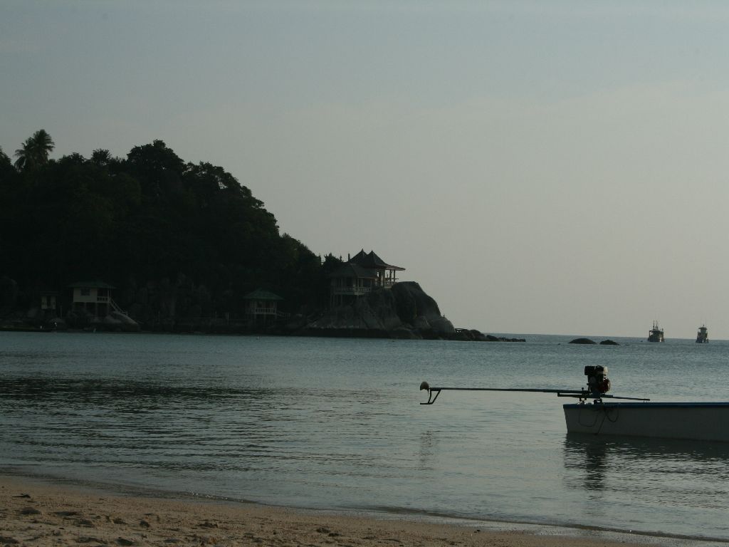 a person in a small boat on the beach
