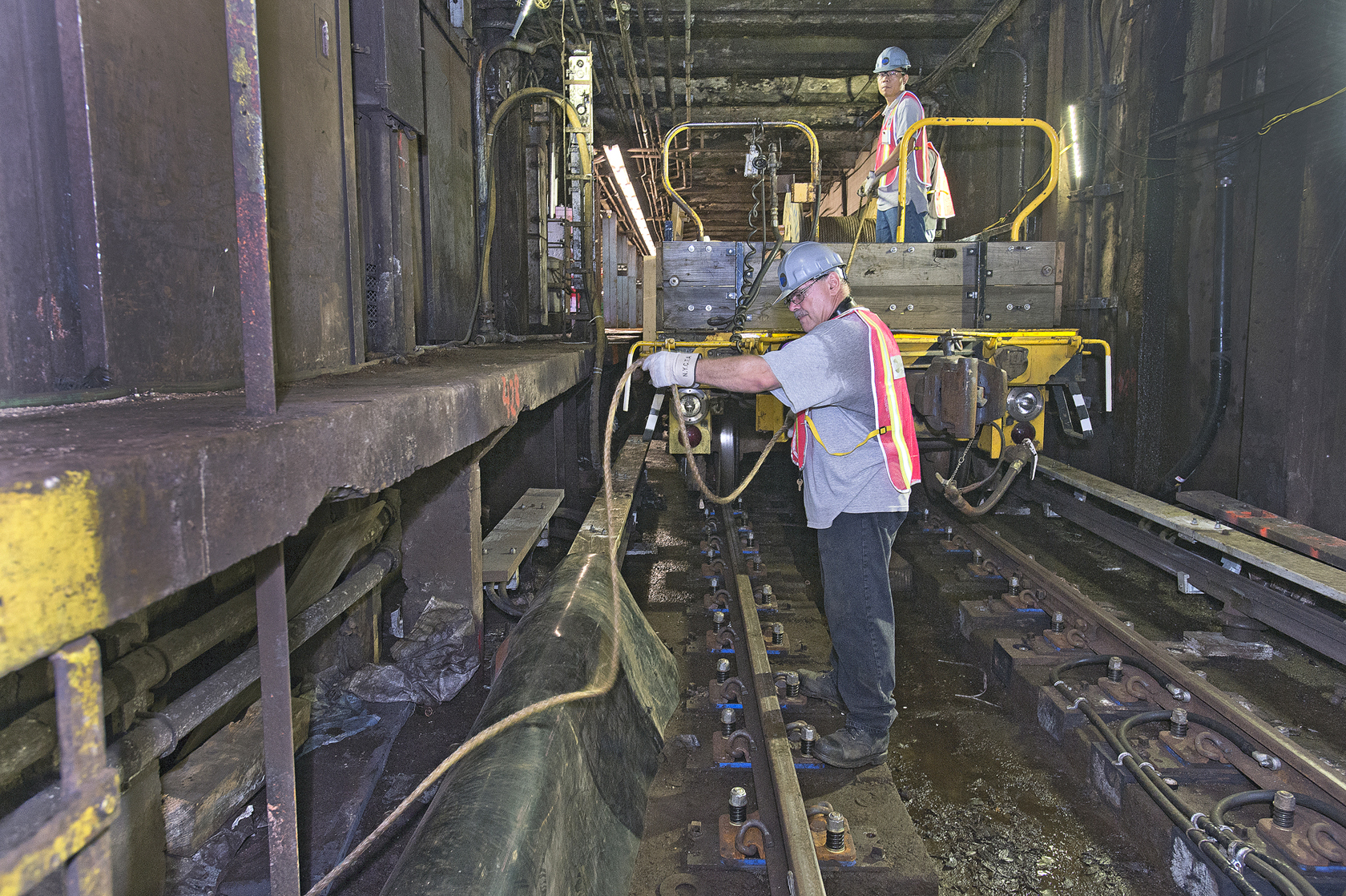 an image of the workers on the train tracks