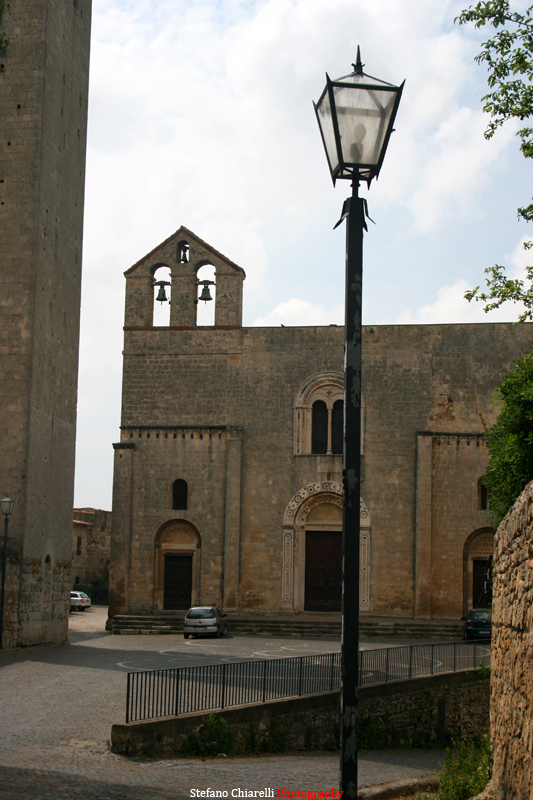 a street light with a church in the background