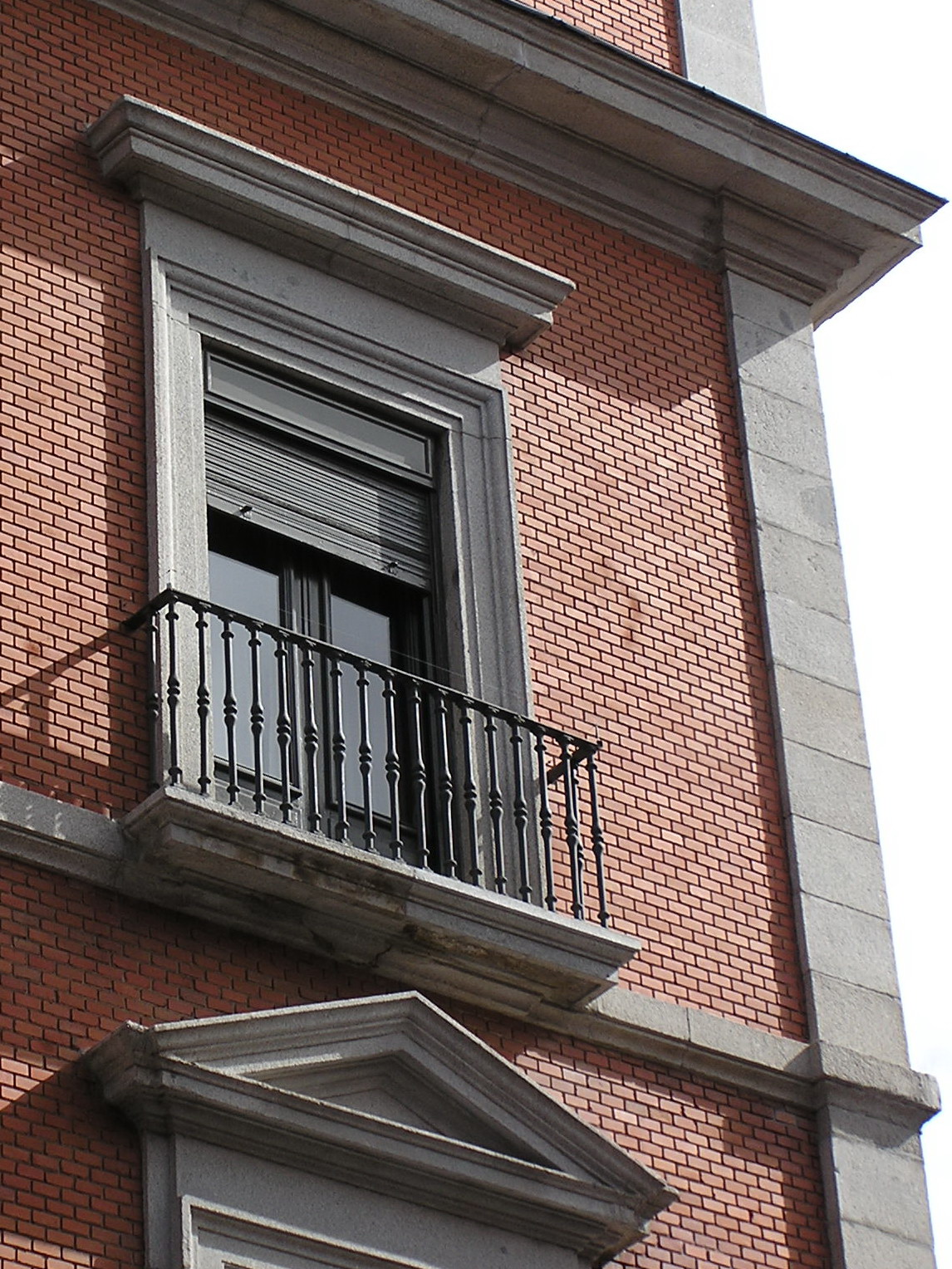 a very tall brick building with a balcony