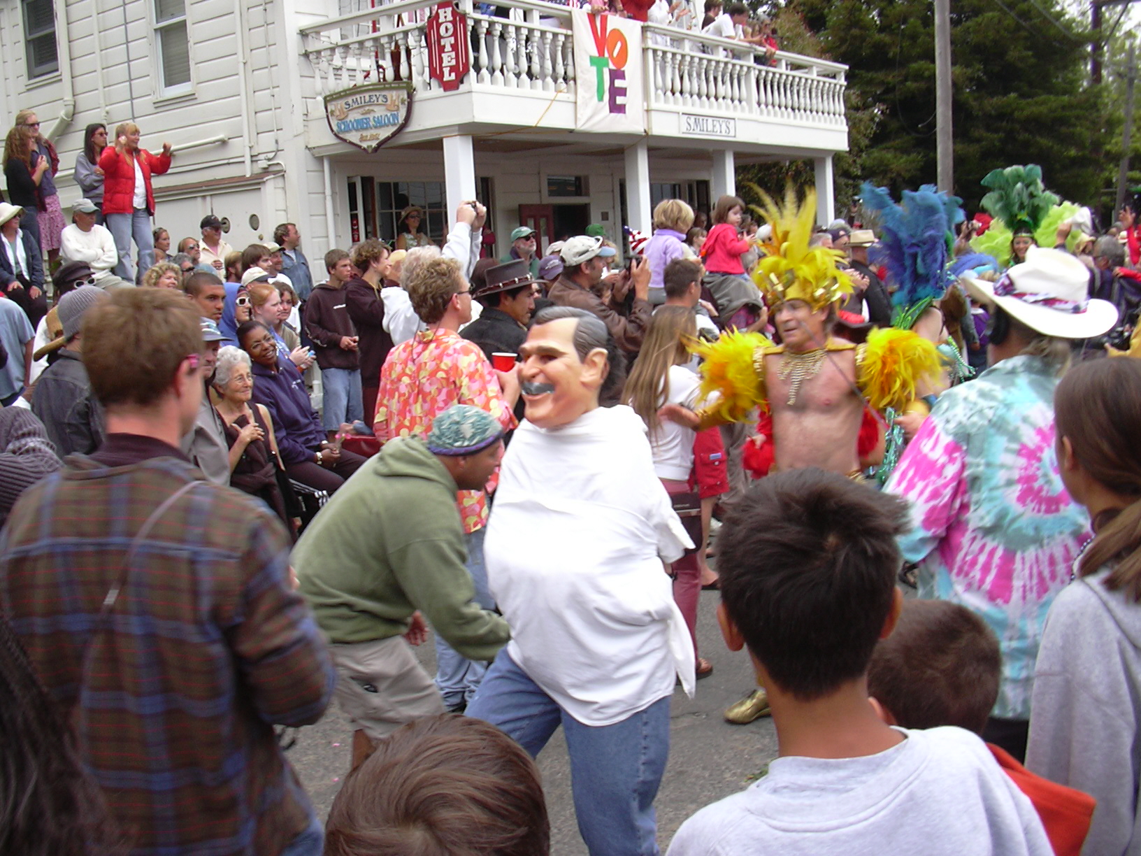 the crowd looks on as a man in costume is dancing with another person