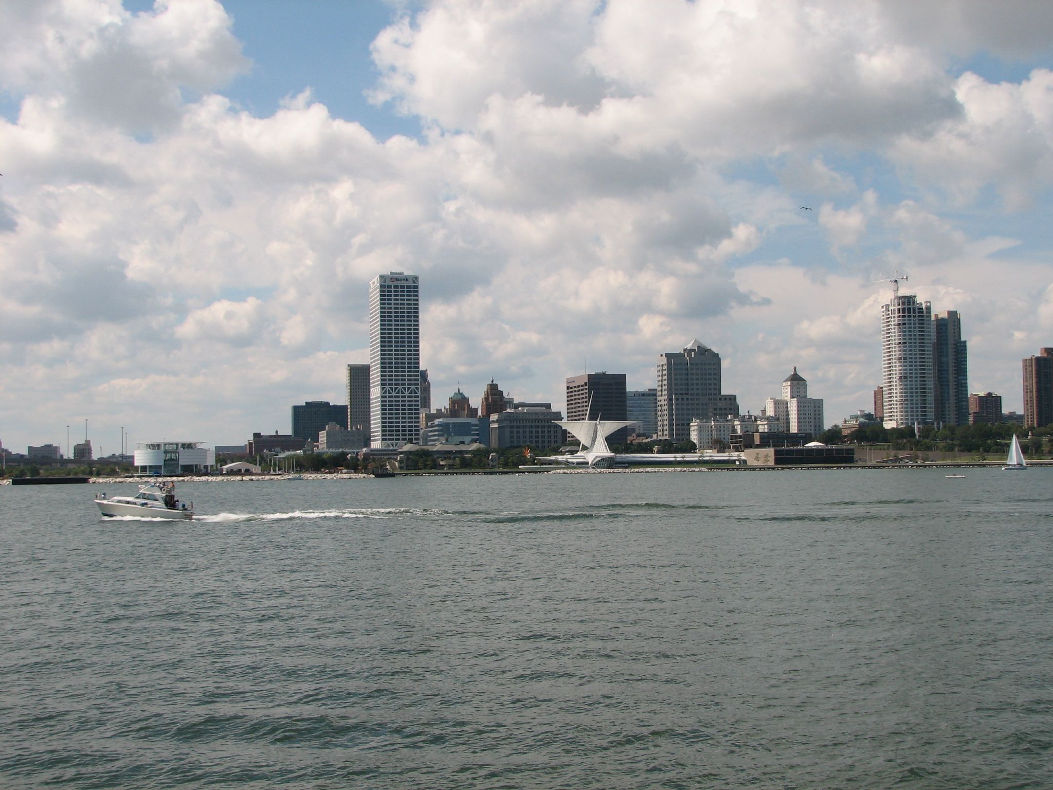 a boat on the water in front of large buildings