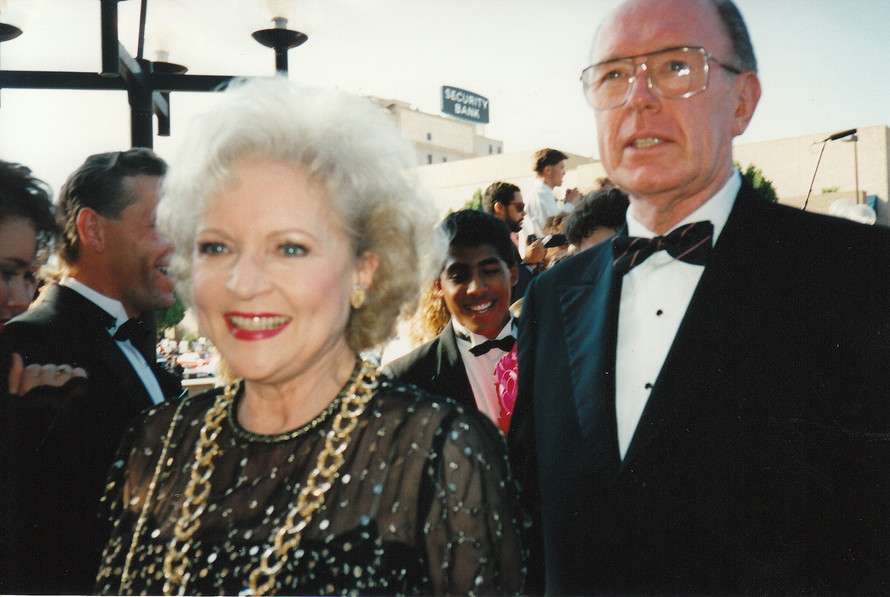 a man and woman dressed in formal wear posing together