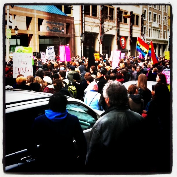there is a large crowd in this street protesting against gay